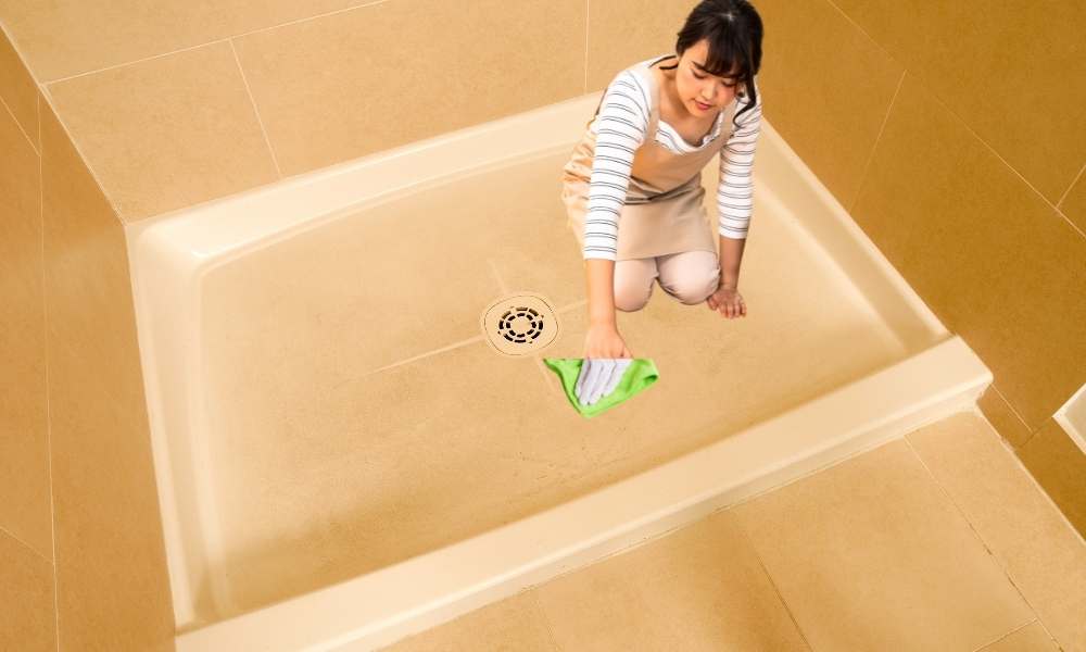 Wipe The Floor of The Plastic Shower With a Damp Cloth